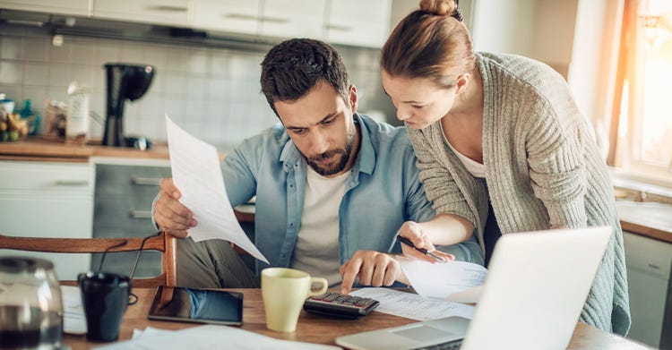 Couple going through finance in the kitchen